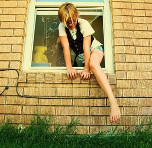 woman climbs out window