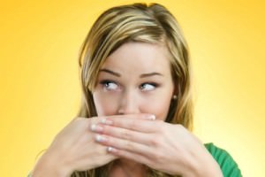 woman covering mouth