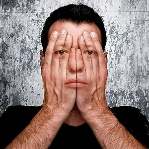 man covering face
